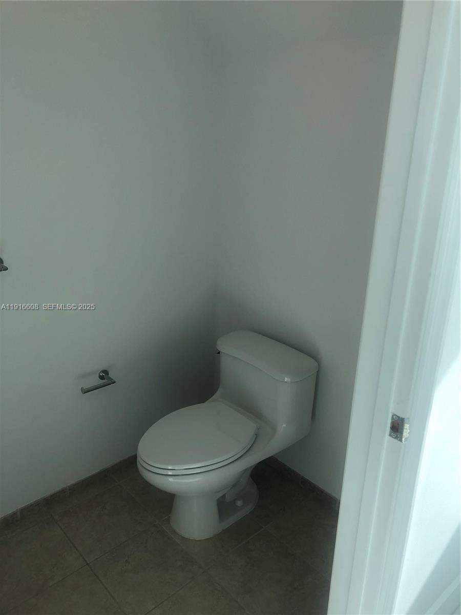 60 Southwest 13th Street, Unit 2803 Miami, FL 33130 - Photo 14 of 17 a white toilet sitting next to a white cabinet
