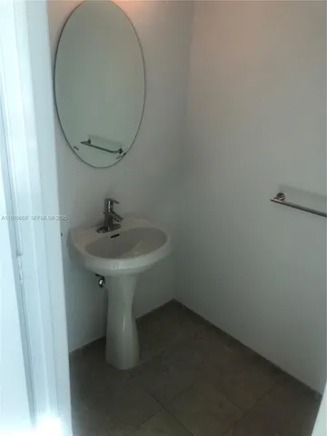 a bathroom with a sink and mirror