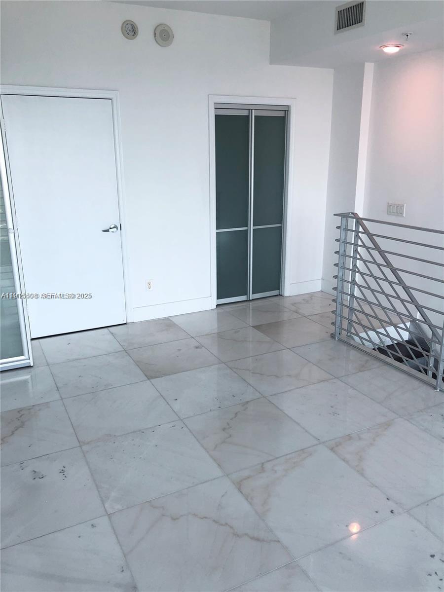 60 Southwest 13th Street, Unit 2803 Miami, FL 33130 - Photo 16 of 17 an empty room with windows