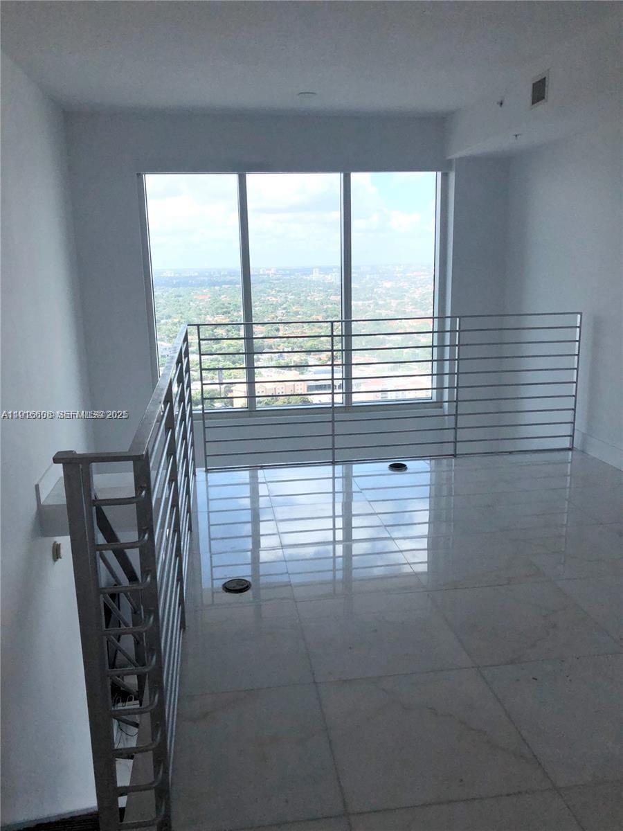 60 Southwest 13th Street, Unit 2803 Miami, FL 33130 - Photo 6 of 17 a view of a room with balcony and furniture