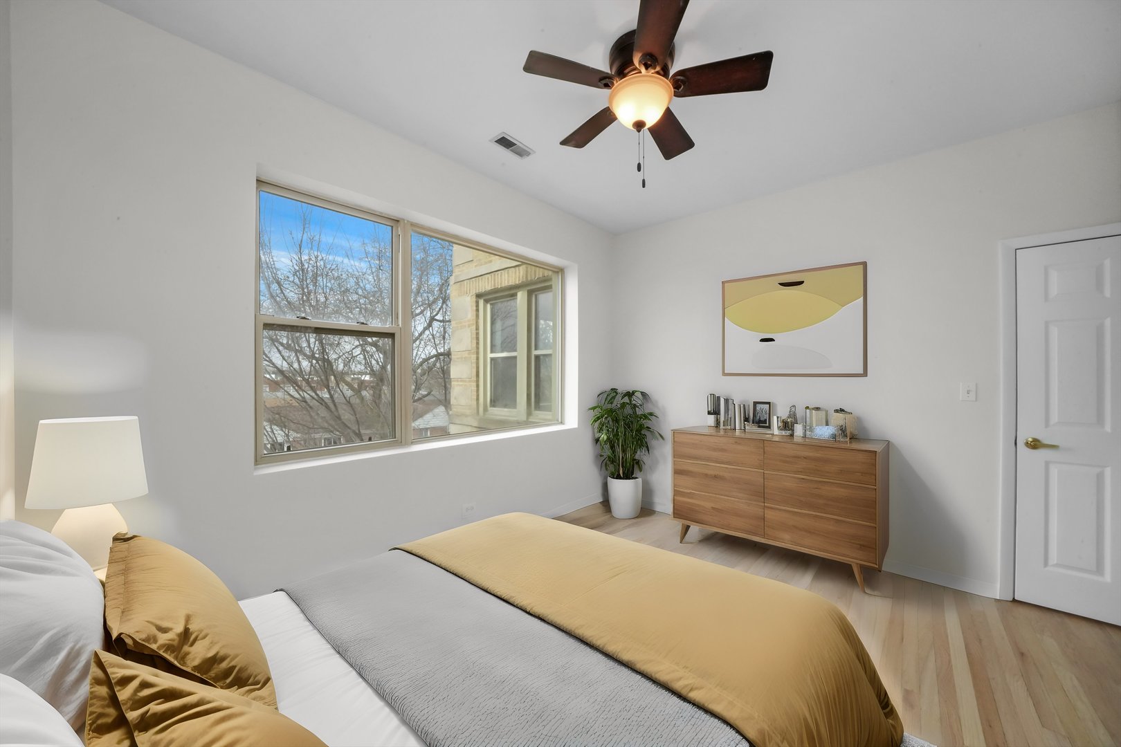 4845 North Harding Avenue, Unit 3 Chicago, IL 60625 - Photo 11 of 17 a bedroom with a bed couch and window