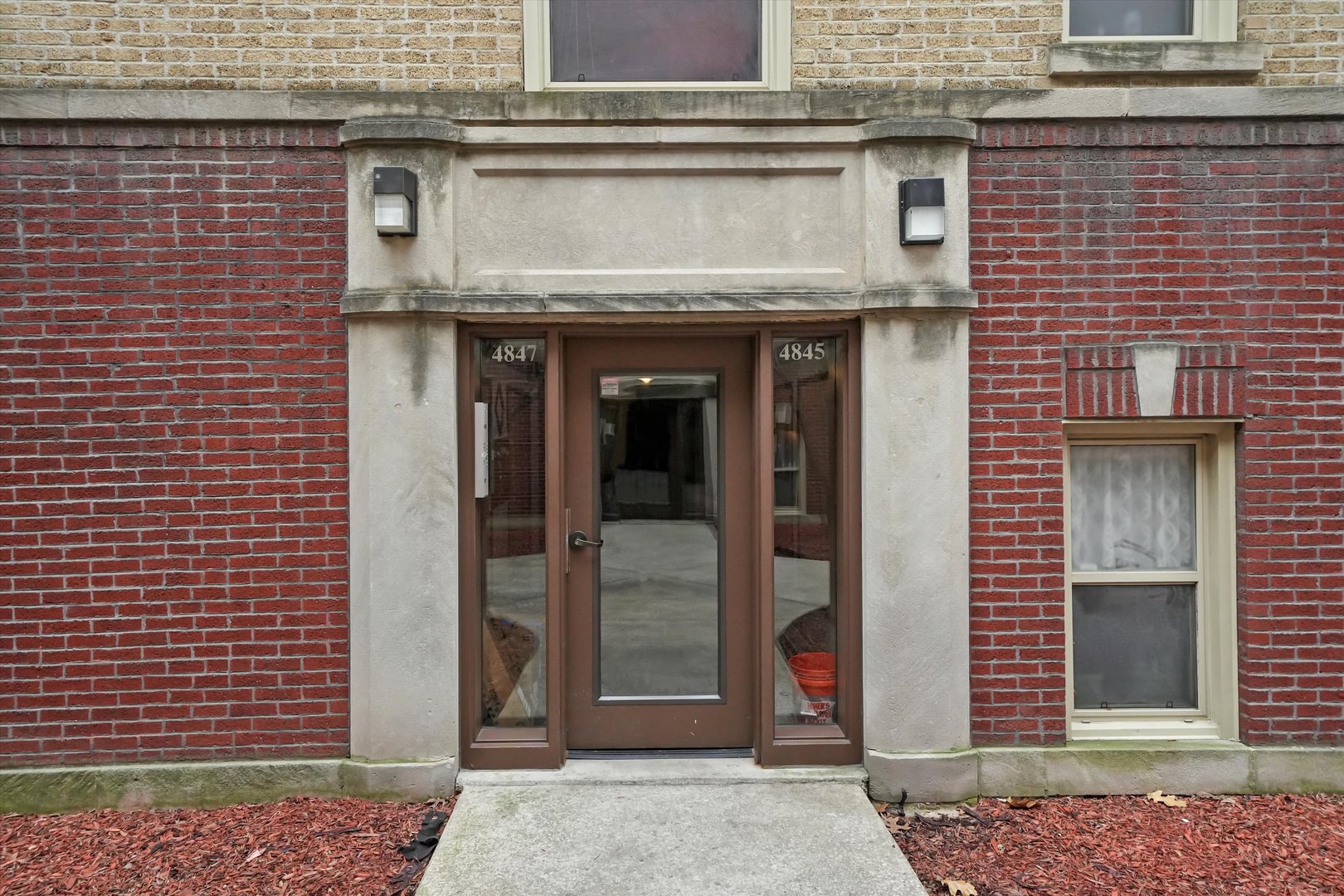 4845 North Harding Avenue, Unit 3 Chicago, IL 60625 - Photo 14 of 17 a view of a brick house with large windows