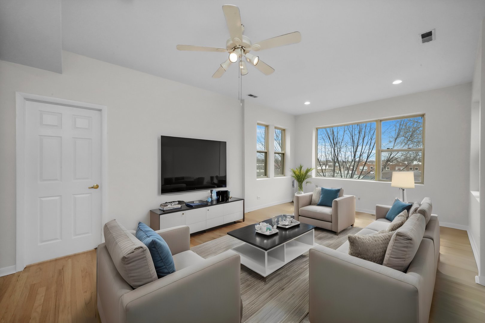 4845 North Harding Avenue, Unit 3 Chicago, IL 60625 - Photo 2 of 17 a living room with furniture and a flat screen tv