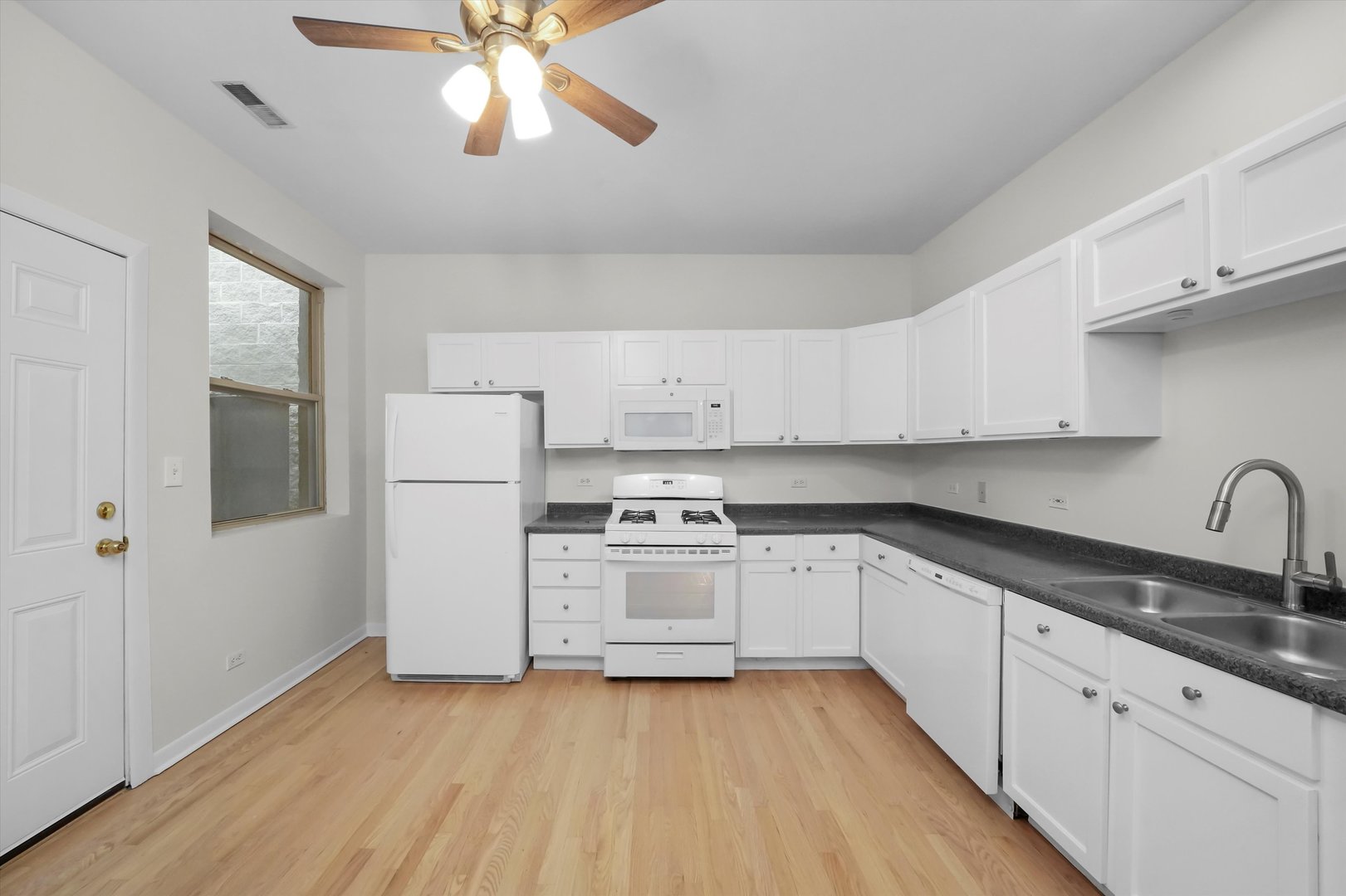4845 North Harding Avenue, Unit 3 Chicago, IL 60625 - Photo 6 of 17 a kitchen with cabinets a sink and appliances