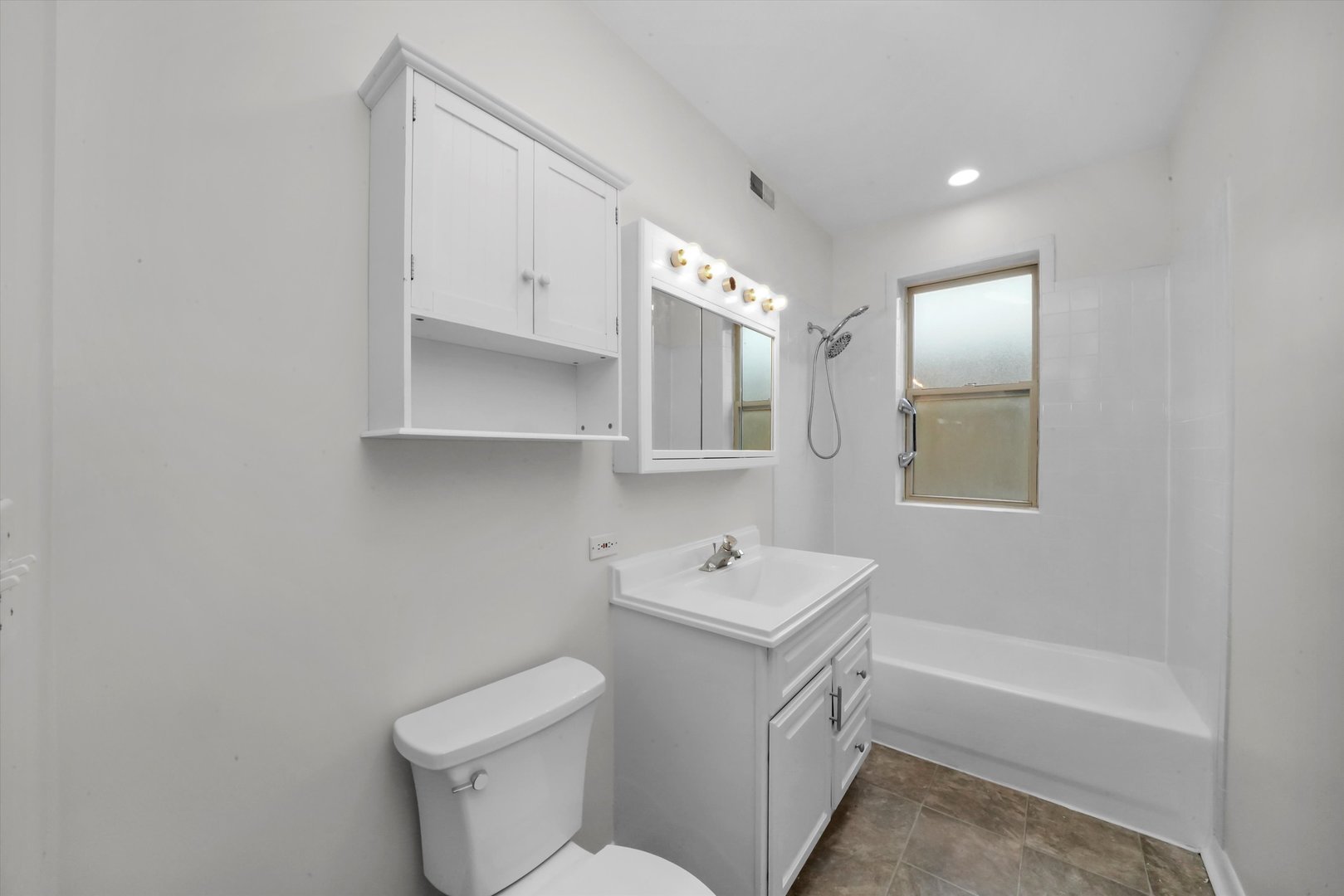 4845 North Harding Avenue, Unit 3 Chicago, IL 60625 - Photo 9 of 17 a bathroom with a toilet sink and mirror