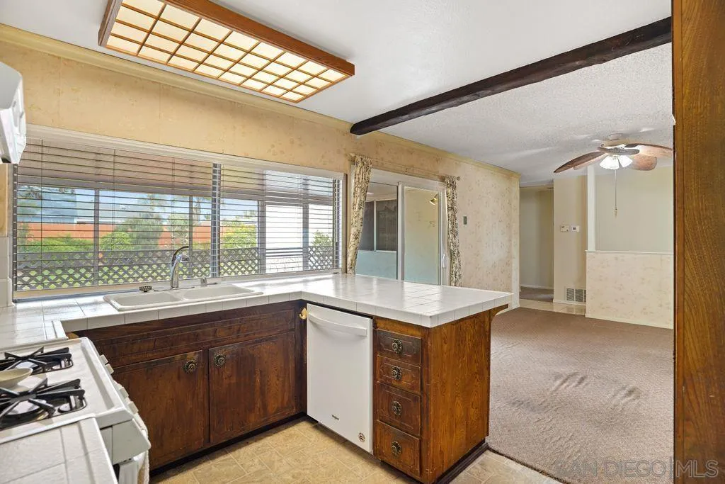 750 Kostner Drive San Diego, CA 92154 - Photo 18 of 34 a kitchen with a stove a sink and a refrigerator