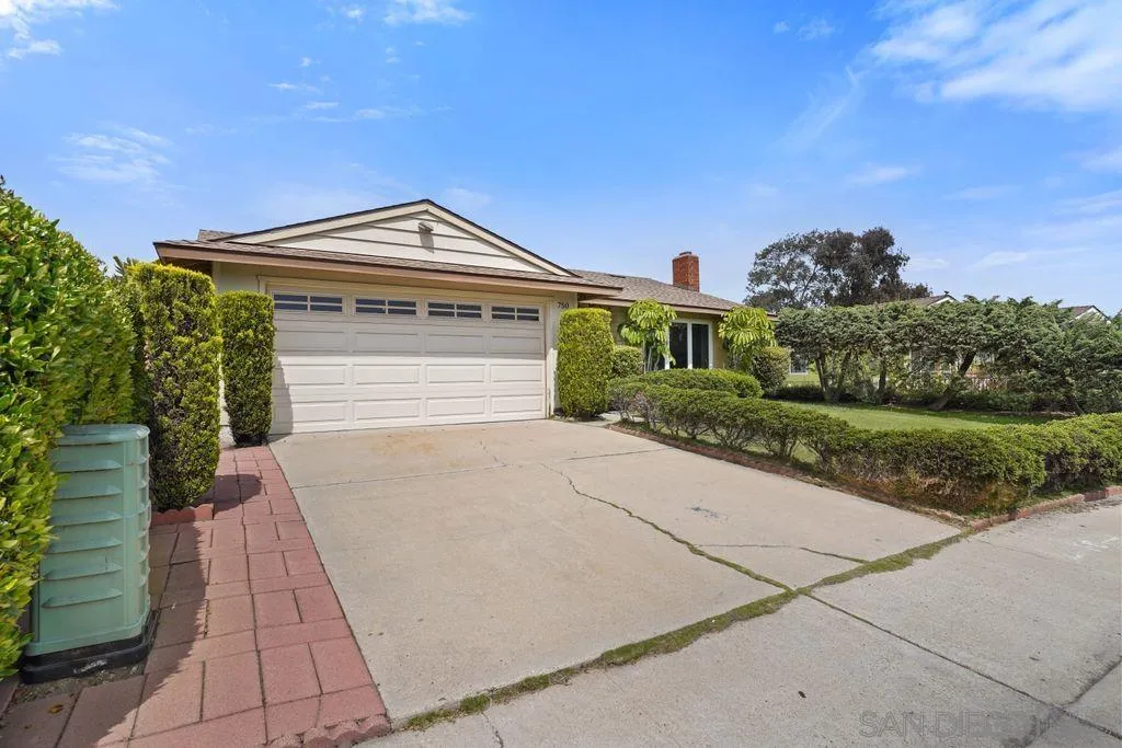 750 Kostner Drive San Diego, CA 92154 - Photo 31 of 34 a front view of a house with a yard and potted plants