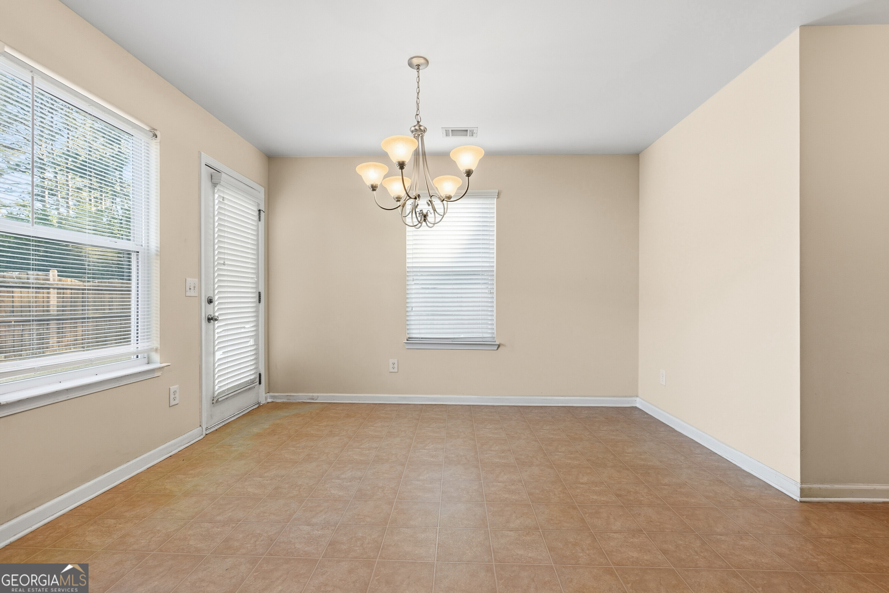 102 Steeple Court Perry, GA 31069 - Photo 12 of 37 wooden floor in an empty room with a window