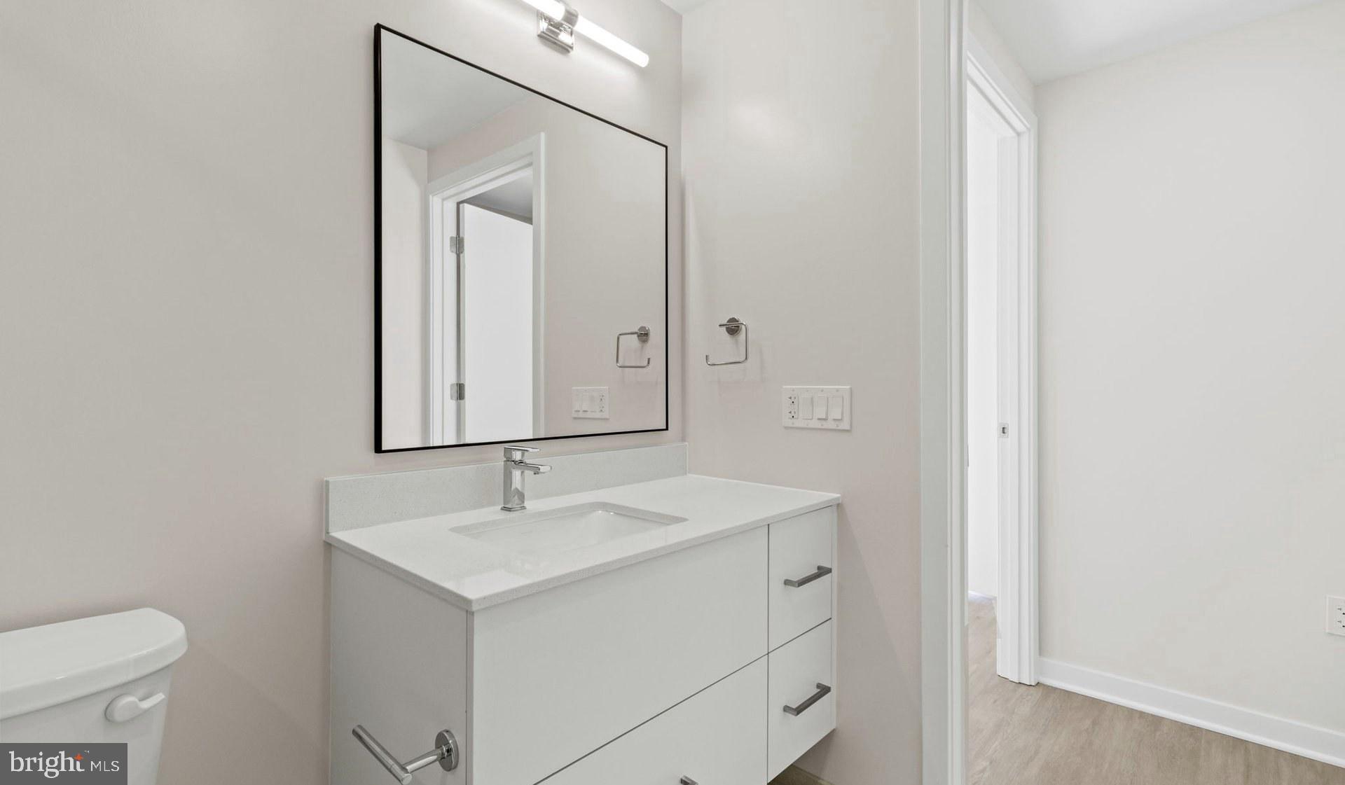4000 Wisconsin Avenue Northwest, Unit 4K236 Washington, DC 20016 - Photo 29 of 54 a bathroom with a sink vanity and a mirror