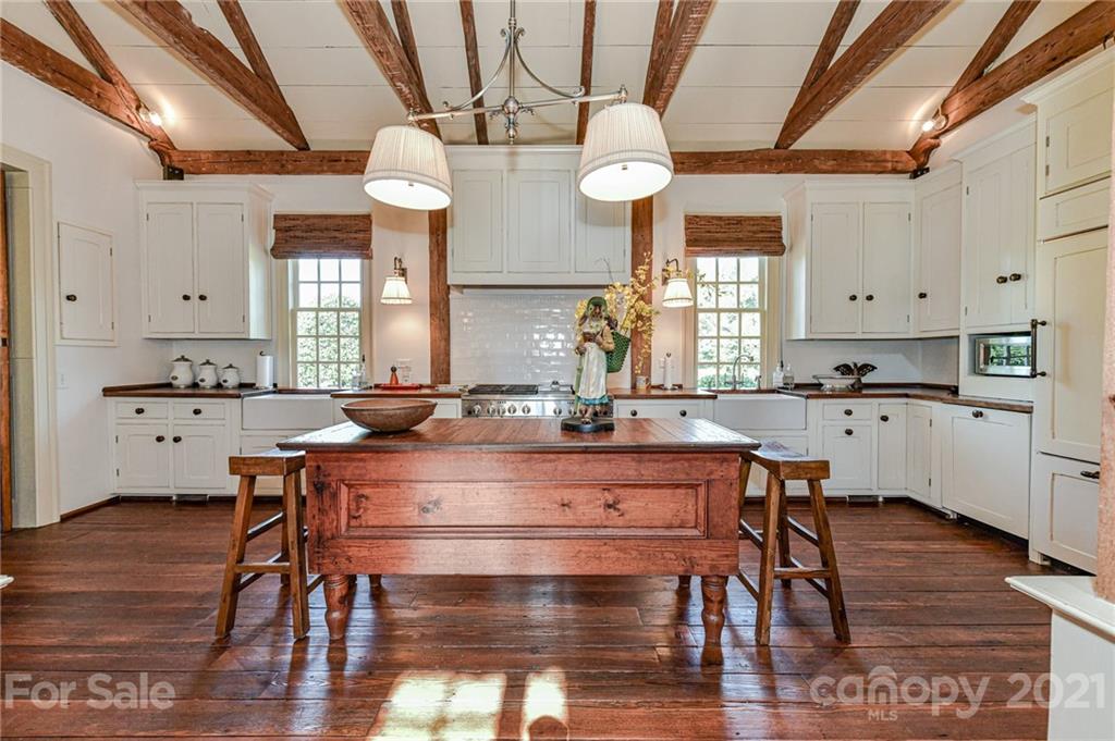 2539 Wooten Road Chester, SC 29706 - Photo 13 of 46 a room with stainless steel appliances kitchen island wooden floors and white walls
