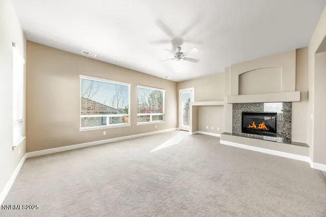 a view of an empty room with a fireplace