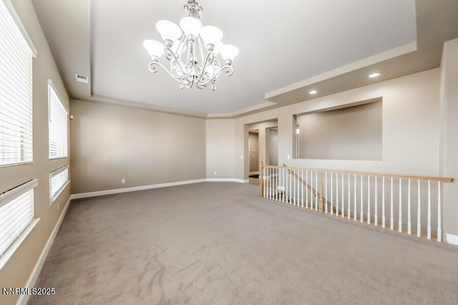 3240 Quartzite Drive Reno, NV 89523 - Photo 15 of 45 en empty room with windows and chandelier