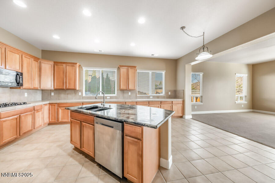 3240 Quartzite Drive Reno, NV 89523 - Photo 9 of 45 a kitchen with stainless steel appliances granite countertop a sink and cabinets