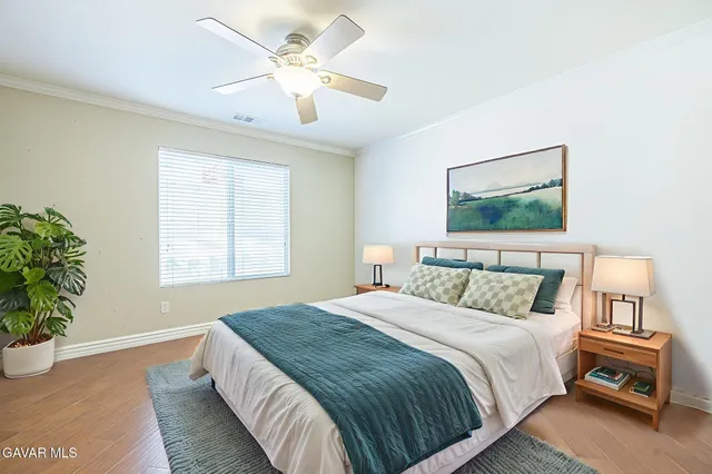 a view of a livingroom with a ceiling fan and window