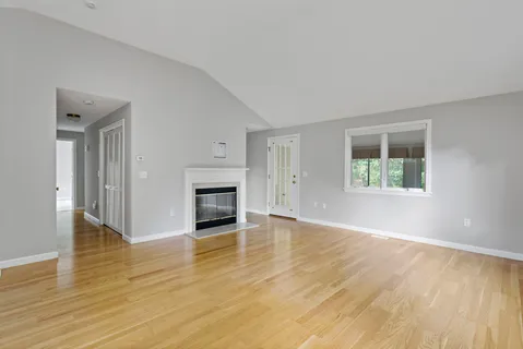 a living room with furniture a fireplace and a table