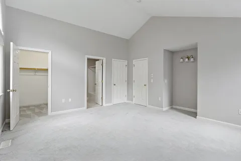 an empty room with windows and closet