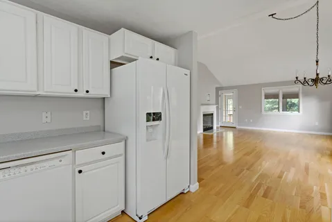 a kitchen with white cabinets and white appliances