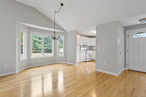 a view of a dining room with furniture window and wooden floor