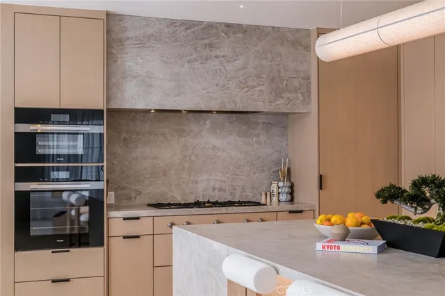 a living room with furniture a flat screen tv and a view of kitchen