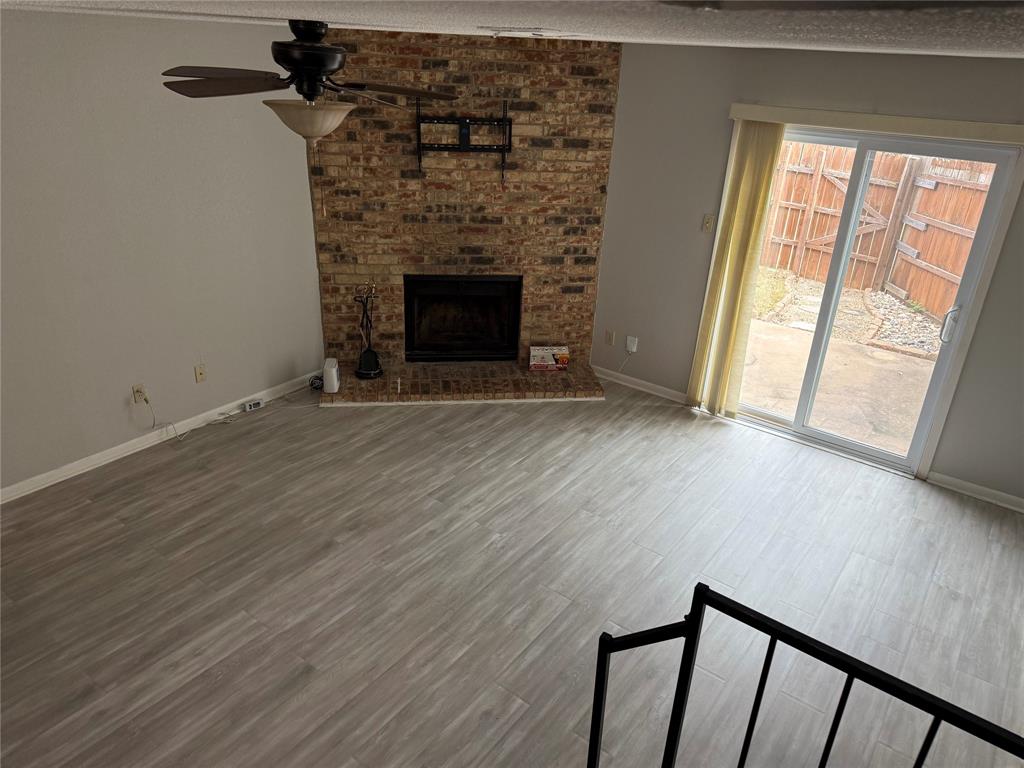 167 Merlin Way Euless, TX 76039 - Photo 13 of 18 a view of an empty room with wooden floor and a window