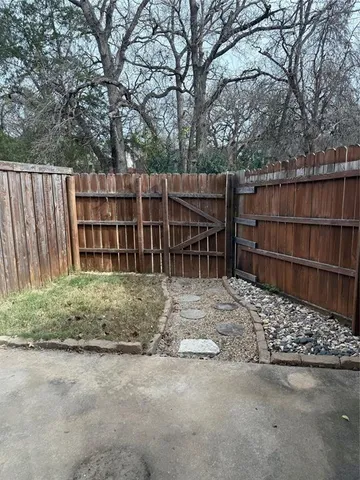 a backyard of a house with wooden fence