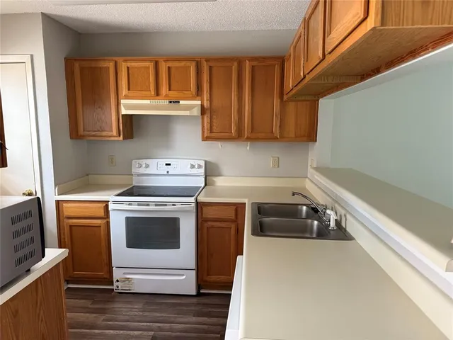 a kitchen with a stove and a refrigerator