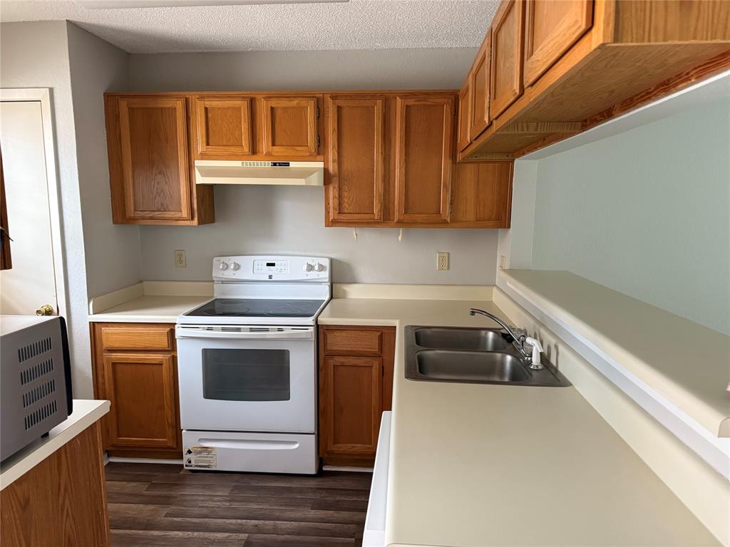 167 Merlin Way Euless, TX 76039 - Photo 3 of 18 a kitchen with a stove and a refrigerator