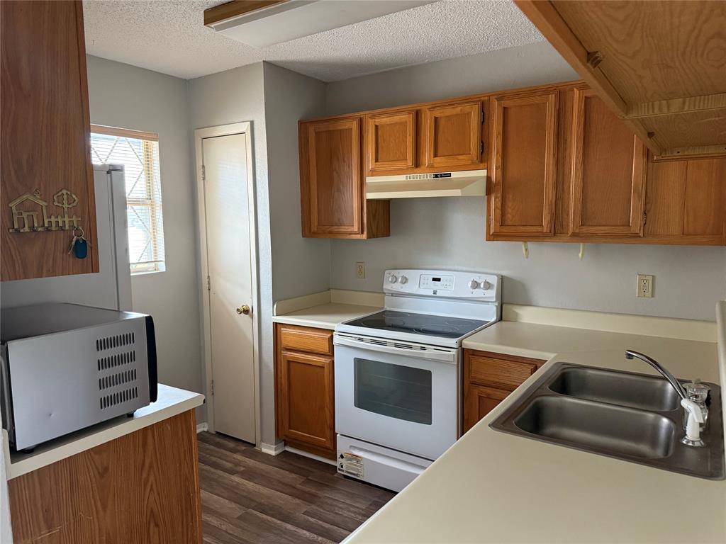 167 Merlin Way Euless, TX 76039 - Photo 4 of 18 a kitchen with a stove and a sink