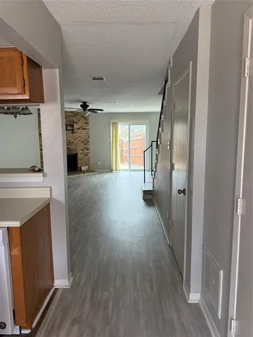 a view of a kitchen from a hallway
