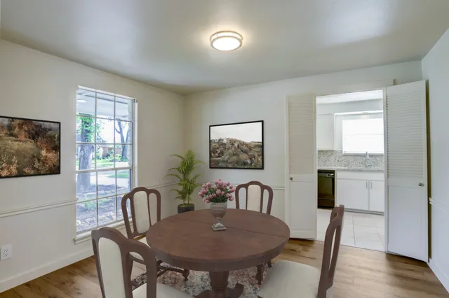 a view of a dining room with furniture window and wooden floor