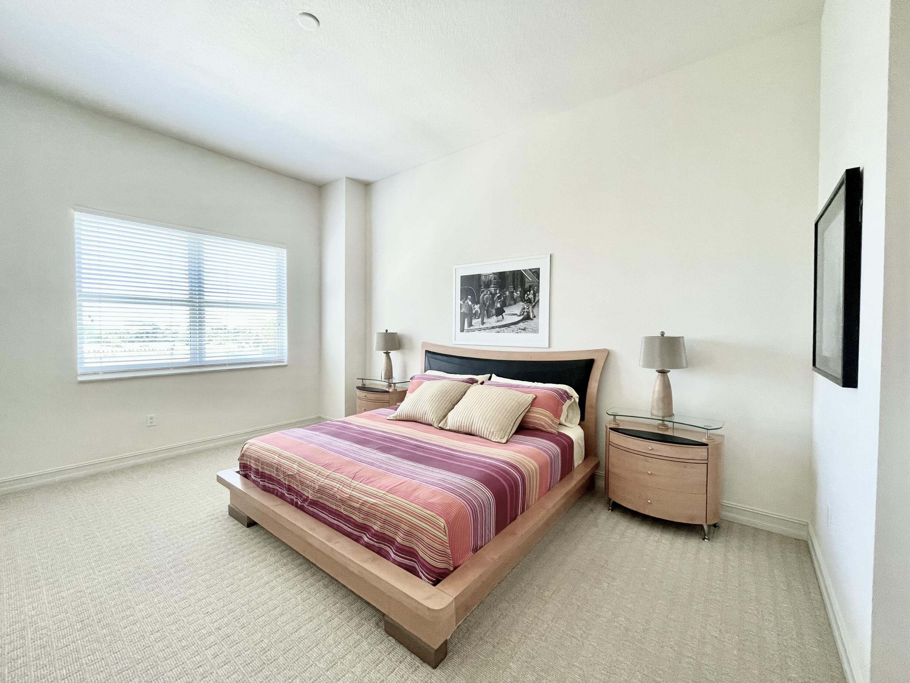 99 Southeast Mizner Boulevard, Unit 509 Boca Raton, FL 33432 - Photo 11 of 28 a bedroom with a bed and a window