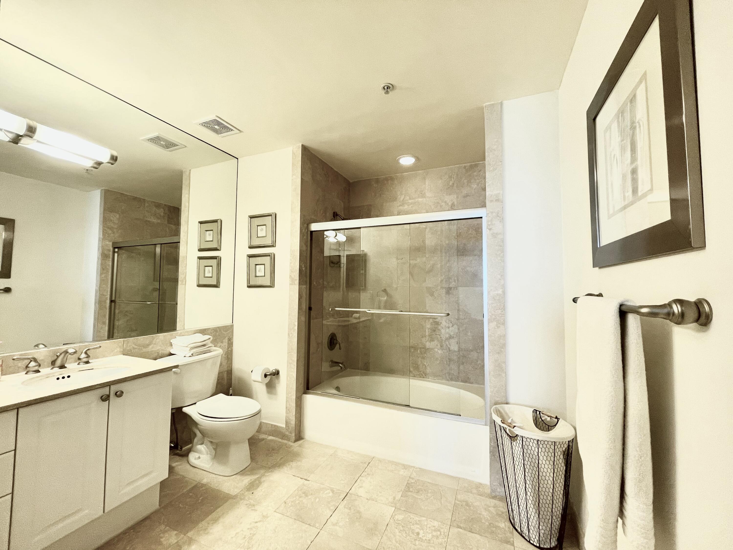 99 Southeast Mizner Boulevard, Unit 509 Boca Raton, FL 33432 - Photo 12 of 28 a bathroom with a bathtub shower sink and toilet