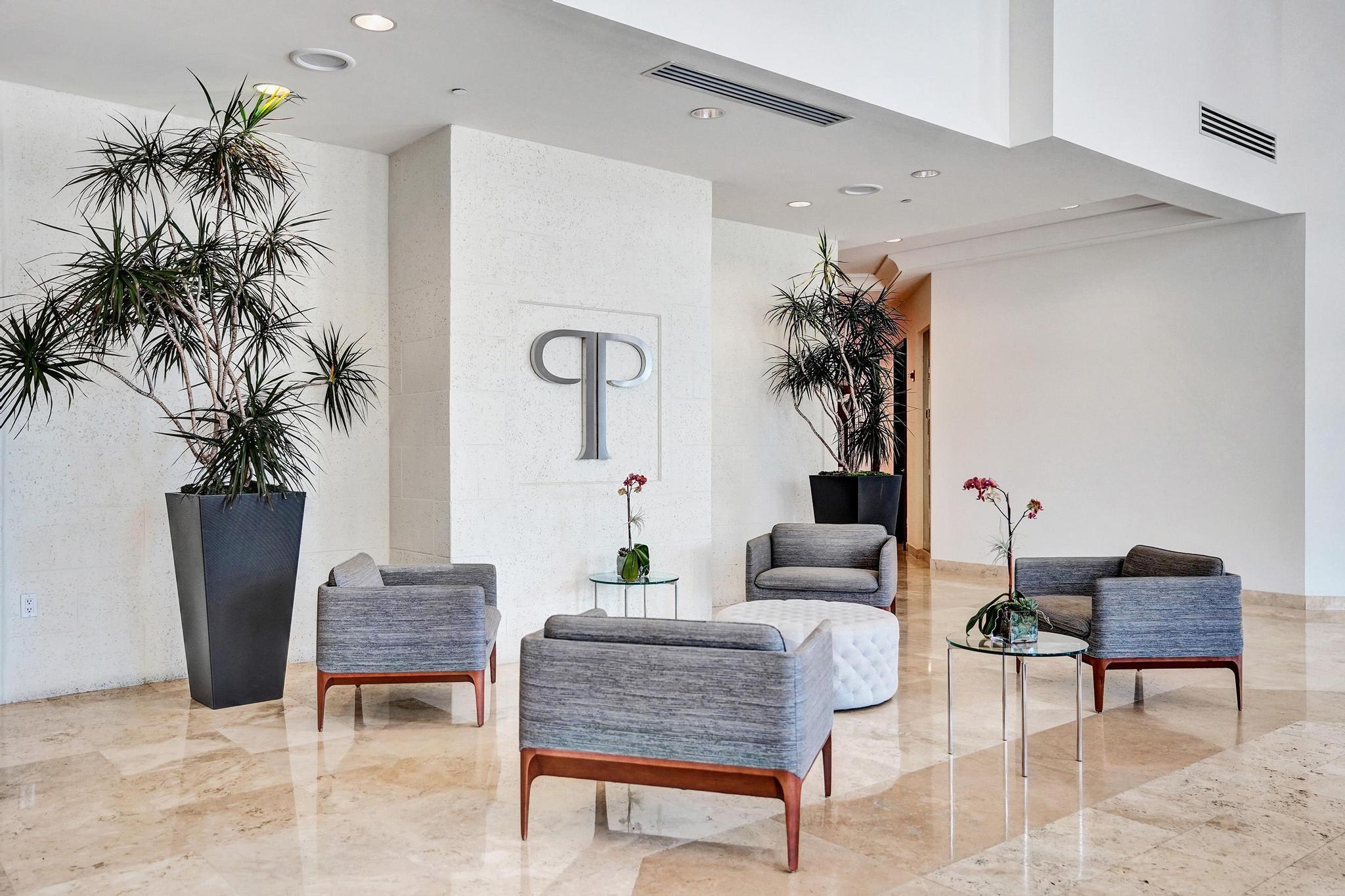 99 Southeast Mizner Boulevard, Unit 509 Boca Raton, FL 33432 - Photo 3 of 28 a living room with furniture and a potted plant