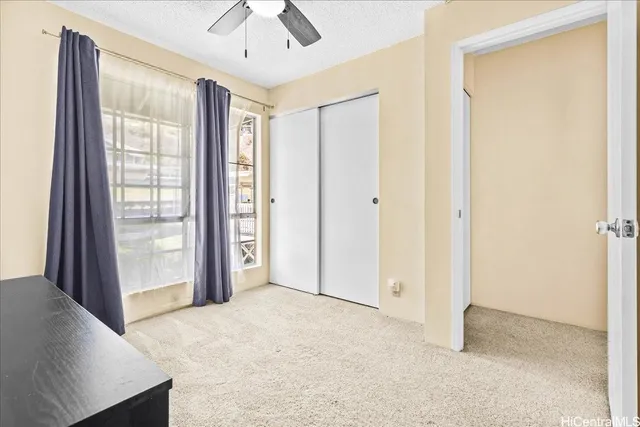 a view of an empty room with a window and storage area