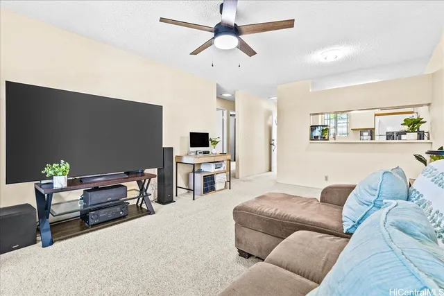 a spacious bedroom with a bed a large window with table and chairs