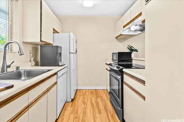 a kitchen with stainless steel appliances granite countertop a sink and a stove