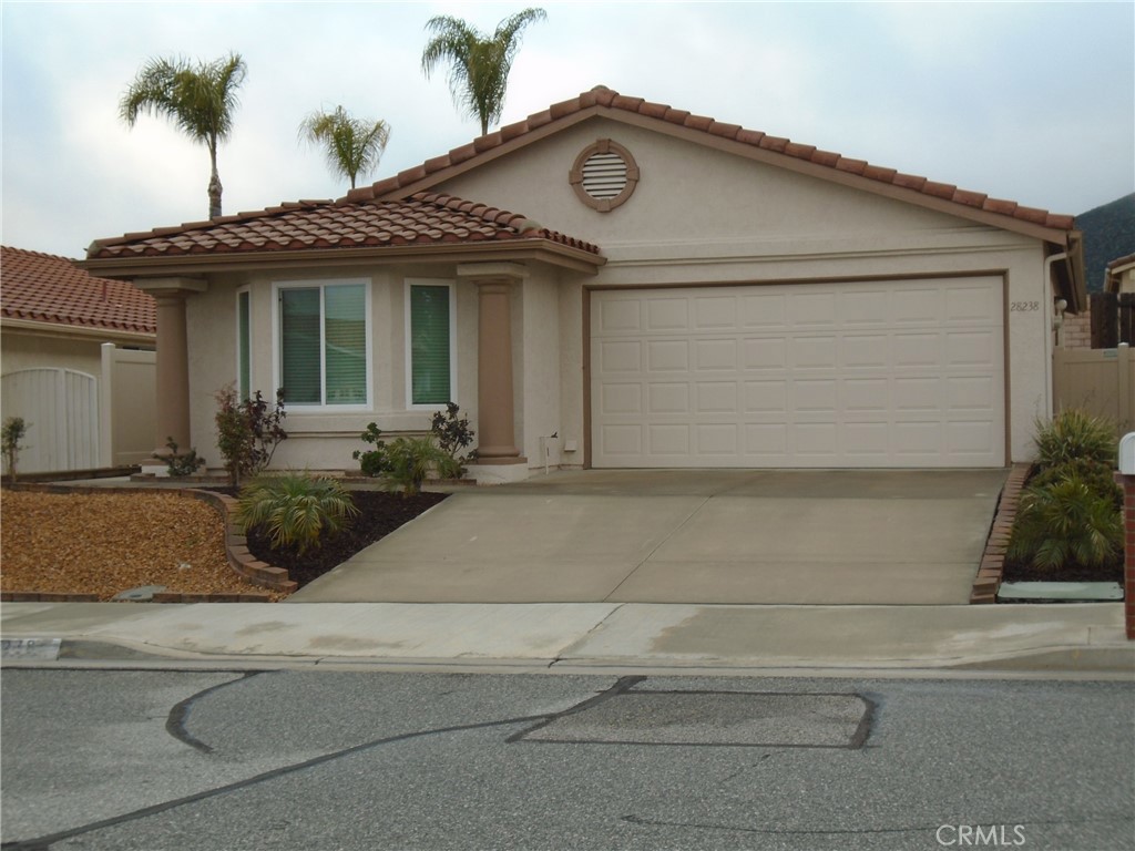28238 Ave Francesca Menifee, CA 92585 - Photo 1 of 1 a front view of a house with a yard and potted plants