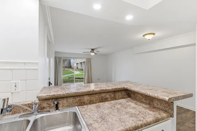 a view of a kitchen with a sink and a window