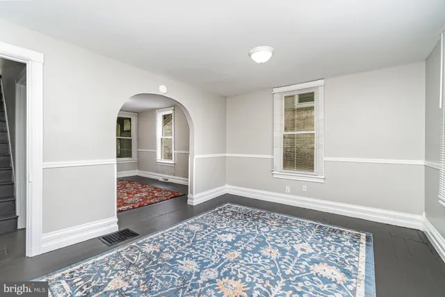 a view of a bedroom with wooden floor and a window