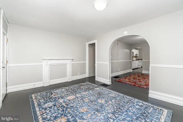 a view of a hallway with wooden floor and cabinet