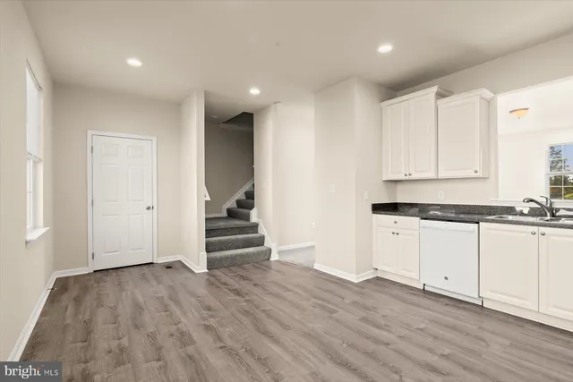 a view of a kitchen with wooden floor and electronic appliances