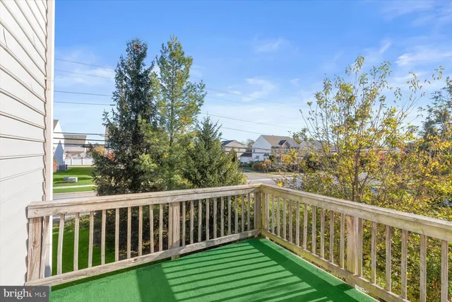 a view of a balcony with wooden fence and floor