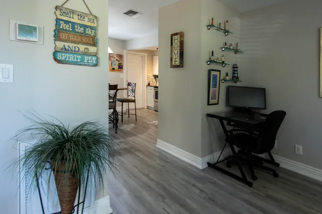 a kitchen with granite countertop a dining table chairs and a refrigerator