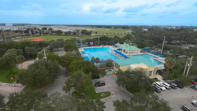 a view of a park with multi story trees