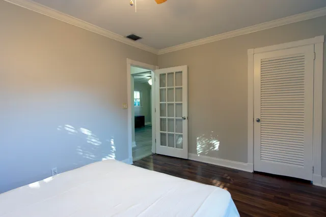 a bathroom with a granite countertop sink a mirror and shower