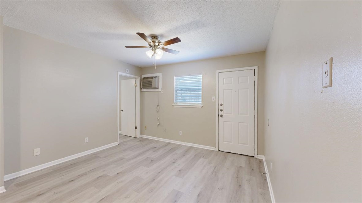 500 Foch Street, Unit 16 Bryan, TX 77801 - Photo 2 of 15 a view of empty room with wooden floor and fan