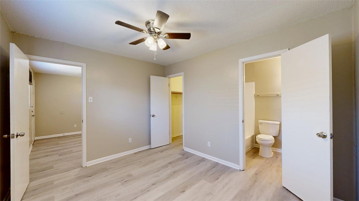 500 Foch Street, Unit 16 Bryan, TX 77801 - Photo 7 of 15 wooden floor in an empty room with a bathroom
