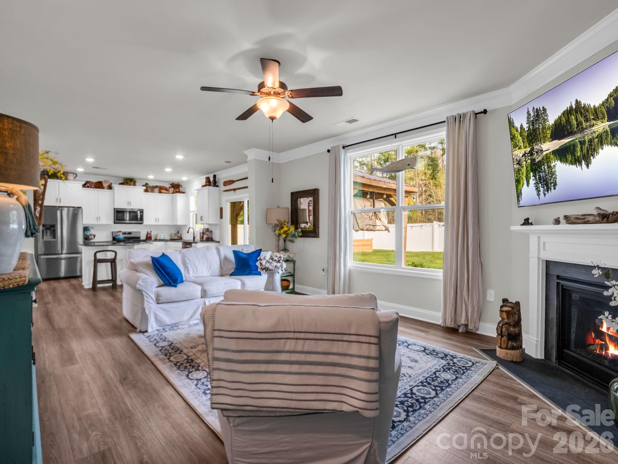 383 Fox Cove Road Hendersonville, NC 28792 - Photo 13 of 34 a living room with furniture a fireplace and a flat screen tv
