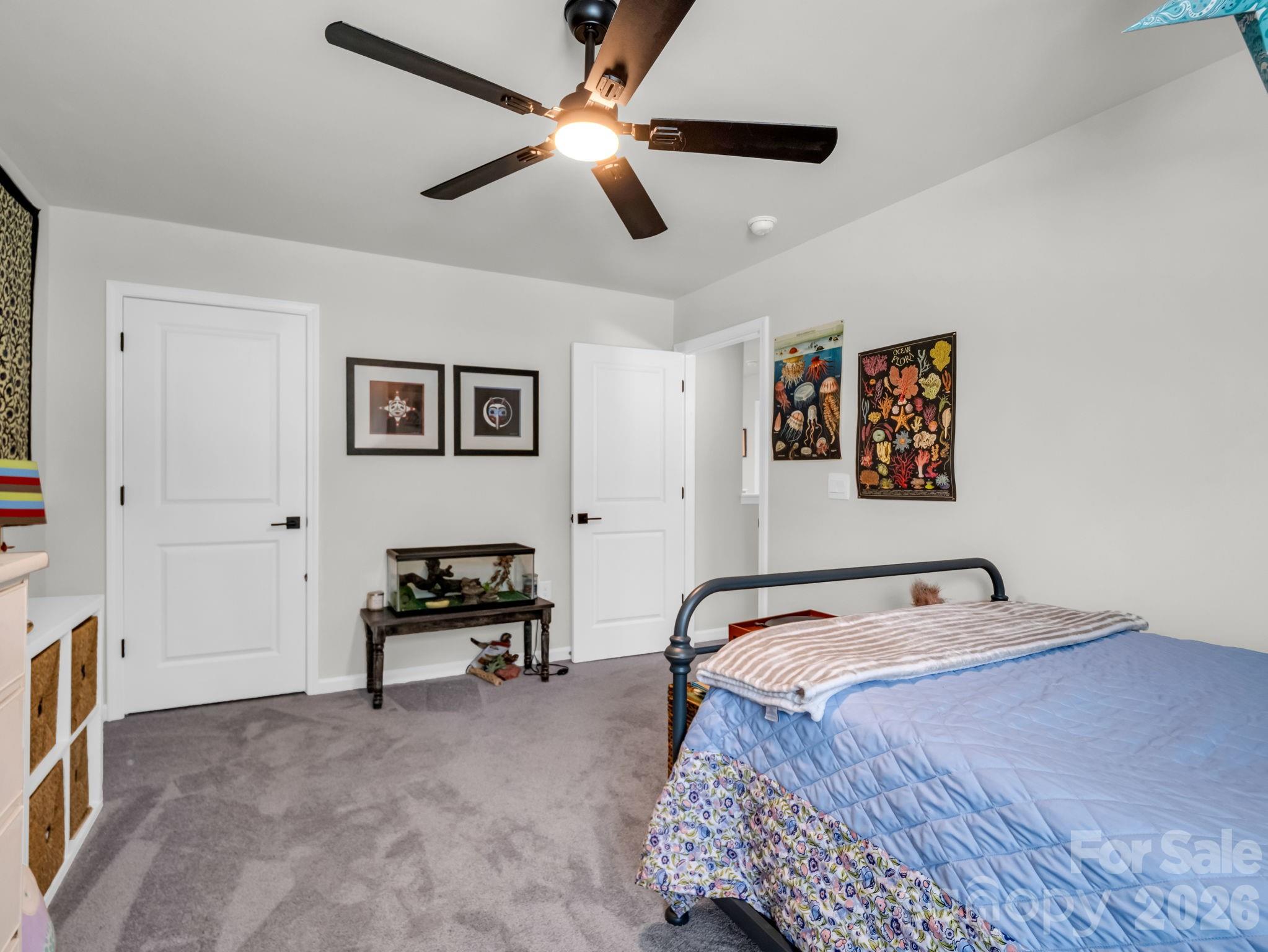 383 Fox Cove Road Hendersonville, NC 28792 - Photo 21 of 34 a bedroom with a bed and a chandelier