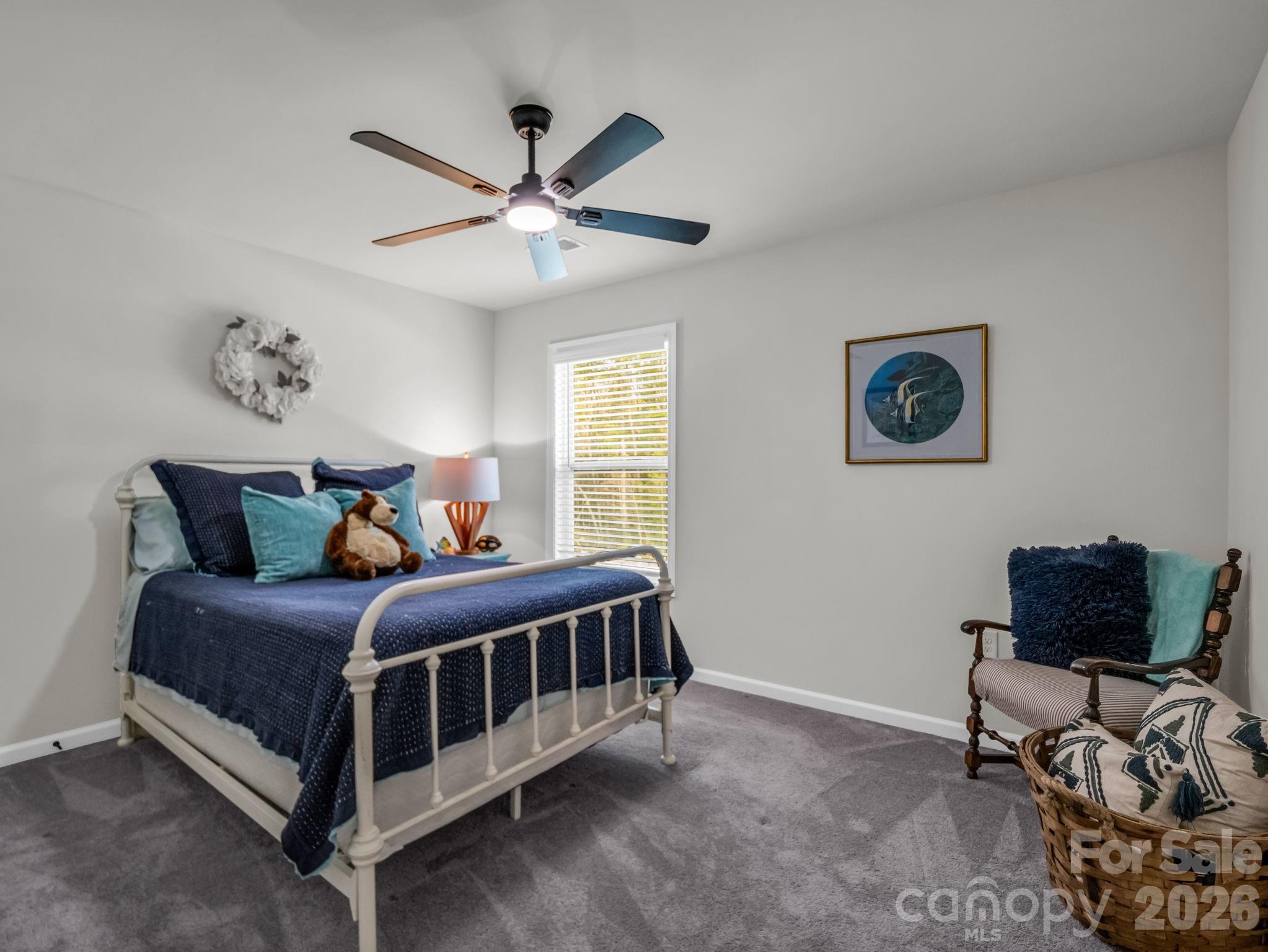 383 Fox Cove Road Hendersonville, NC 28792 - Photo 22 of 34 a bedroom with a bed a couch and a window